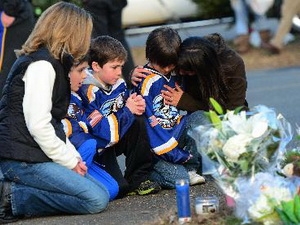 Trẻ em cùng gia đình tưởng niệm các nạn nhân tại Sandy Hook ngày 15-12 vừa qua. Ảnh: AFP