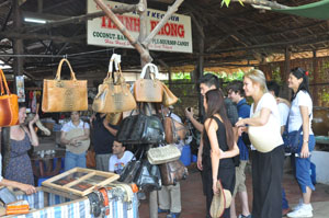 Du khách mua sắm tại một điểm du lịch sinh thái ở huyện Cái Bè.