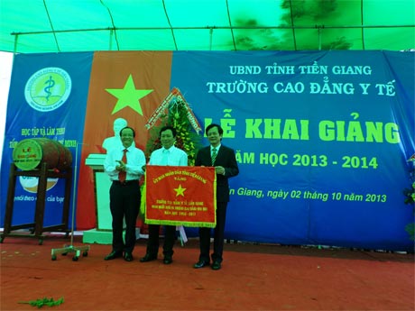 Ông Trần Thanh Đức, Phó Chủ tịch UBND tỉnh trao Cờ thi đua của UBND tỉnh cho Ban Giám hiệu Trường Cao đẳng Y tế Tiền Giang.