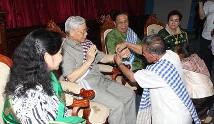 Tổng Bí thư Nguyễn Phú Trọng và Phu nhân cùng Tổng Bí thư, Chủ tịch nước Lào Chummaly Sayasone và Phu nhân dự Lễ buộc chỉ cổ tay chúc phúc.