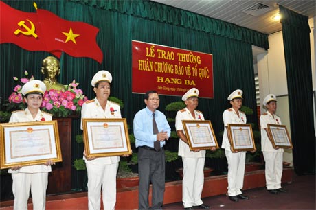 Chủ tịch UBND tỉnh Nguyễn Văn Khang trao tặng Huân chương cho các cá nhân.