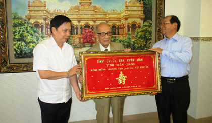 Bí thư Tỉnh ủy Trần Thế Ngọc và Phó Chủ tịch UBND tỉnh trao khánh mừng thượng thọ GS Vũ Khiêu (đứng giữa)