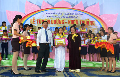 Ông Đặng Thanh Liêm, Chủ tịch UBND TP. Mỹ Tho và bà Trần Thị Quý Mão, Phó Giám đốc Sở GD-ĐT trao thưởng cho các em.