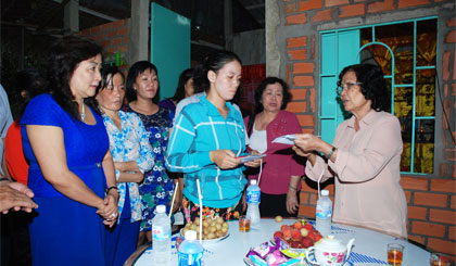 GS-BS Nguyễn Thị Ngọc Phượng trao tiền cho vợ của  điều dưỡng Võ Văn  Đấu. 