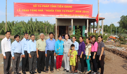 Các đại biểu tham dự Lễ trao tặng nhà “Nghĩa tình tư pháp” chụp hình lưu niệm cùng gia đình đ/c Trần Văn Trổ.