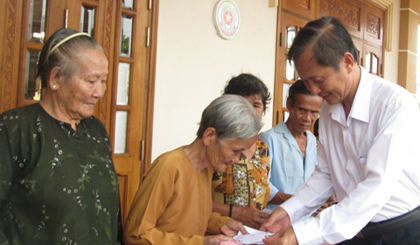 Ông Đinh Văn Hữu, Chủ tịch Hội đồng thành viên công ty tặng quà tết cho bà con nghèo xã Bình Đức.