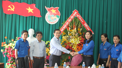 Chairman of the PPC Le Van Huong presents flower to representative of the Provincial Ho Chi Minh Communist Youth Union