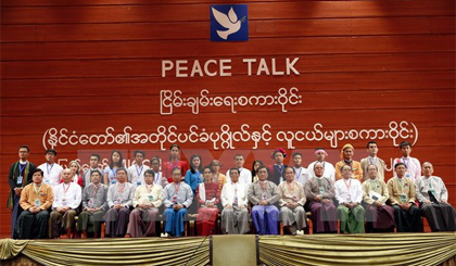 Cố vấn Nhà nước Aung San Suu Kyi (giữa) chụp ảnh với các đại biểu tại Hội nghị hòa bình ở Naypyitaw, Myanmar ngày 1-1. Nguồn: EPA/TTXVN