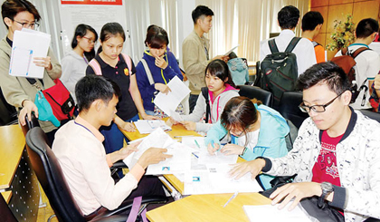 Students finish paperwork for enrolment lát year (Photo: SGGP)