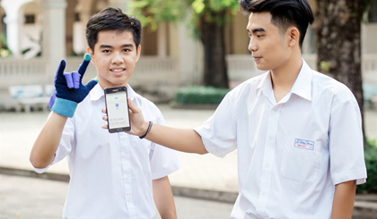 Listen to the hand: Tan (left) wears the talking glove that allows a smart phone to translate sign language into text and speech. The gesture says, 