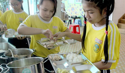 Students at an elementary school in District 11, Ho Chi Minh City receive their lunch portions planned by the ‘Designing nutritionally balanced menus’ platform.