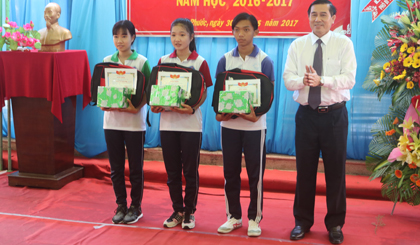 Ông Lê Văn Hưởng, Chủ tịch UBND tỉnh (bìa phải), trao thưởng cho học sinh có thành tích xuất sắc trong năm học 2016 - 2017 của Trường THPT Nguyễn Văn Tiếp.