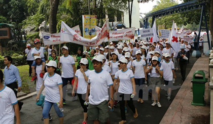Participants of the charity walk to call for support for Agent Orange (AO)/dioxin victims and disabled people in Ho Chi Minh City (Photo: VNA)
