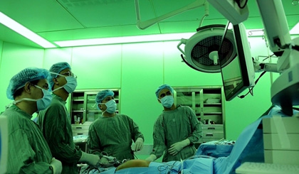 Doctors at the HCM City University Medical Centre perform a laparoscopic liver surgery.