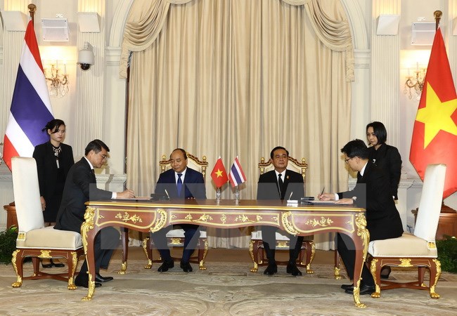 Thủ tướng Nguyễn Xuân Phúc và Thủ tướng Thái Lan Prayut Chan-o-cha chứng kiến Lễ ký Bản ghi nhớ hợp tác giữa Ngân hàng Nhà nước Việt Nam và Ngân hàng Thái Lan. Ảnh: Thống Nhất/TTXVN