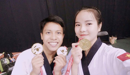 Lê Trần Kim Uyên and Trần Hồ Duy selfie with their gold medal at the Canada Open. 