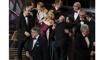 Guillermo del Toro (L) accepts the Oscar for Best Picture for 
