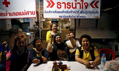 Volunteers celebrate at a press centre near Tham Luang cave complex. (Photo: Reuters)