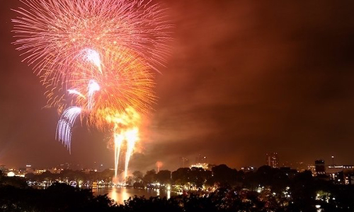 Glittering firework shows lit up the sky over Hanoi's Hoan Kiem Lake on lunar New Year's Eve.