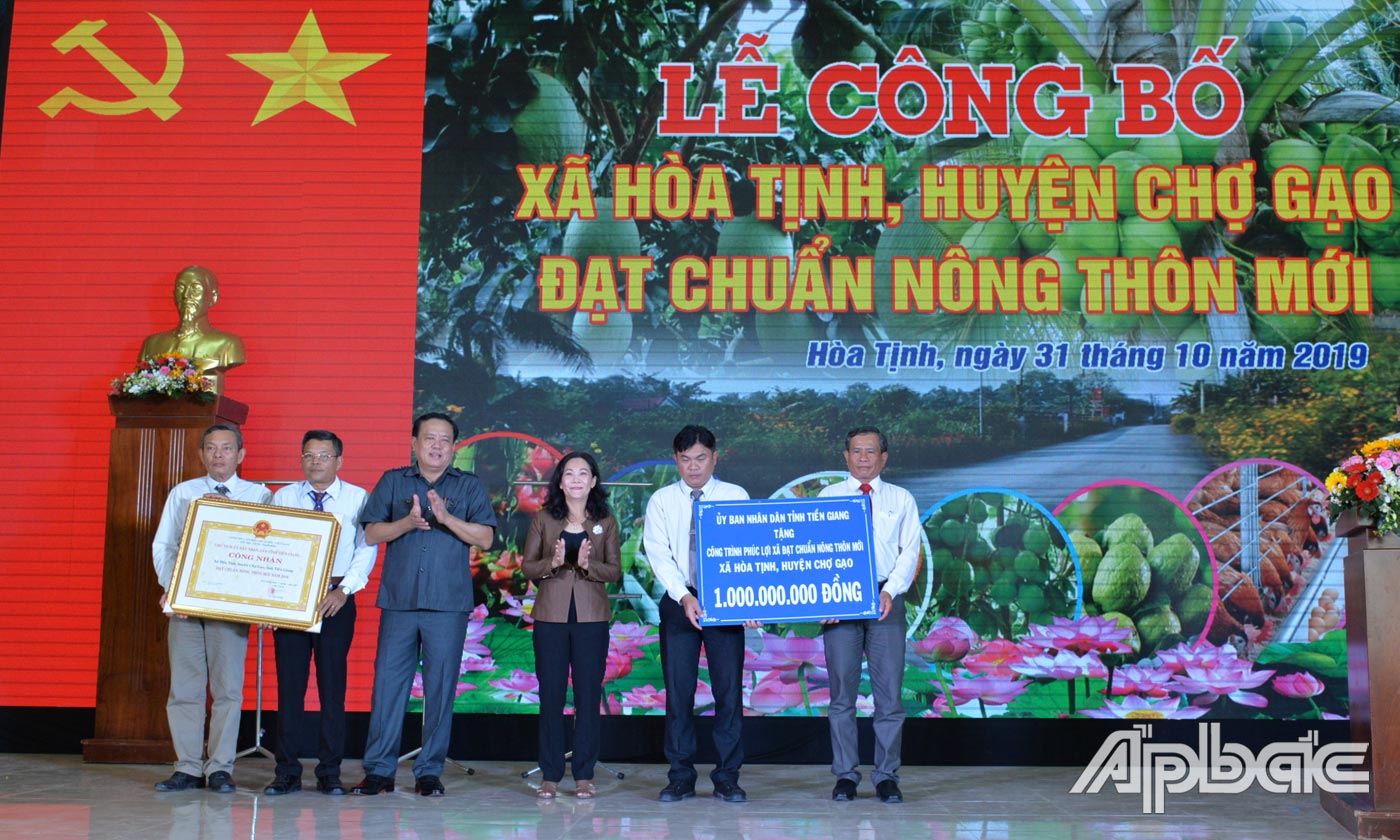 Đồng chí Nguyễn Thị Sáng và đồng chí Lê Văn Nghĩa trao Bằng công nhận và Bảng tượng trưng tặng công trình phúc lợi trị giá 1 tỷ đồng cho xã Hòa Tịnh.