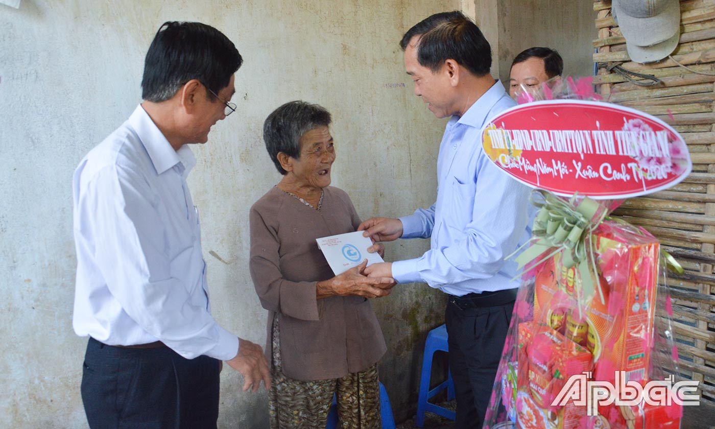 Đồng chí Nguyễn Văn Vĩnh trao quà cho các gia đình chính sách, hộ nghèo của xã Mỹ Trung.