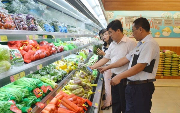 Inspectors check food in a supermarket in Hanoi. Photo thanhtra.vn