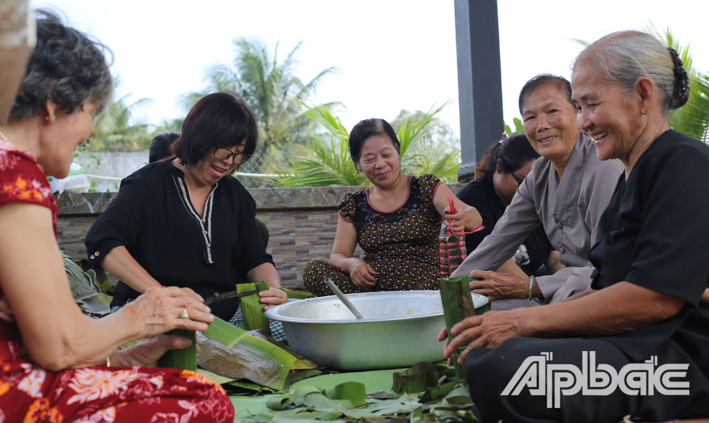 Bà con xã Tam Hiệp, huyện Châu Thành cùng nhau gói bánh tét gửi đến nhân dân miền Trung bị ảnh hưởng lũ lụt. 