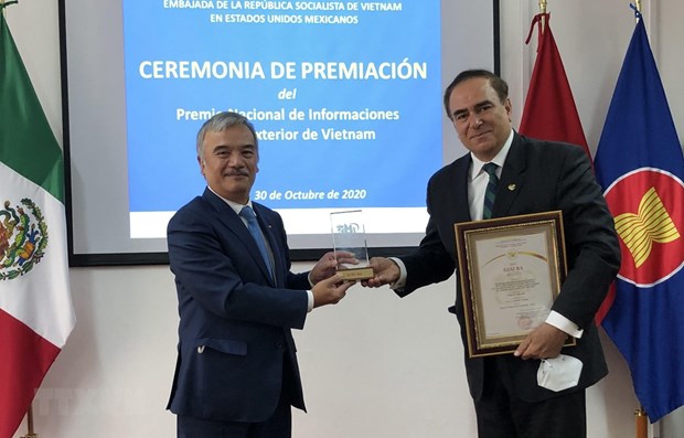Vietnamese Ambassador to Mexico Nguyen Hoai Duong (L) hands over the third prize to Mouris Salloum George, President of the Club of Journalists and Editor-in-Chief of Voces Magazine (Source: VNA).