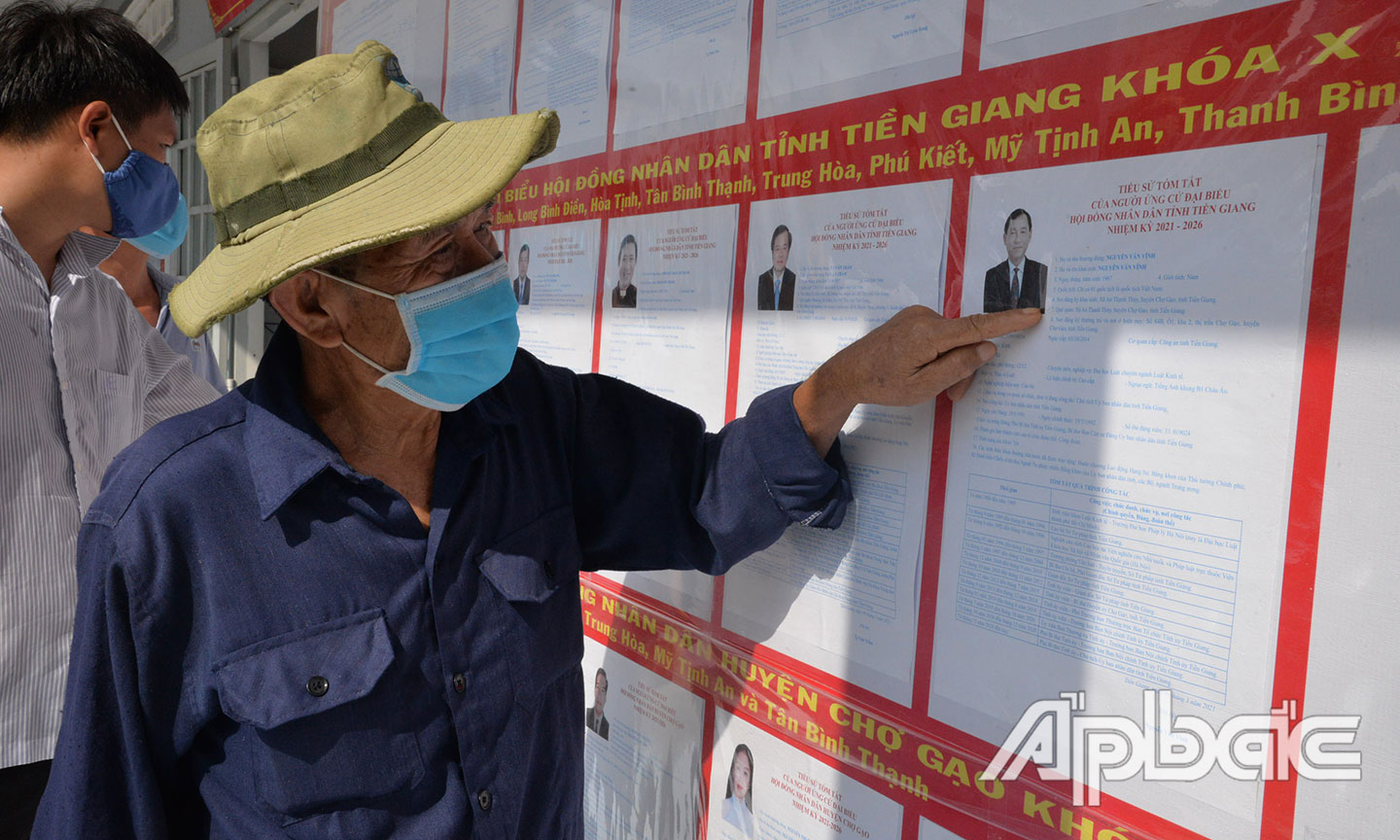 Cử tri xem tiểu sử của các ửng cử viên tại điểm tiếp xúc xã Mỹ Tịnh An, huyện Chợ Gạo .