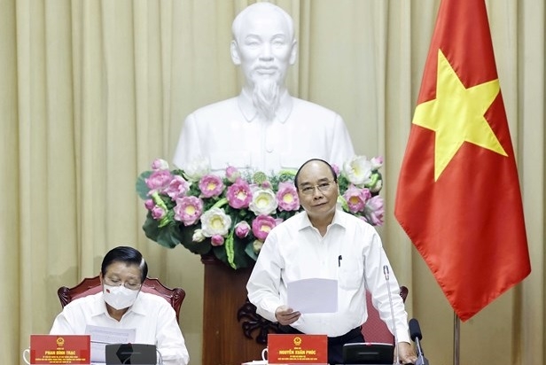 State President Nguyen Xuan Phuc speaks at the meeting. (Photo: VNA).