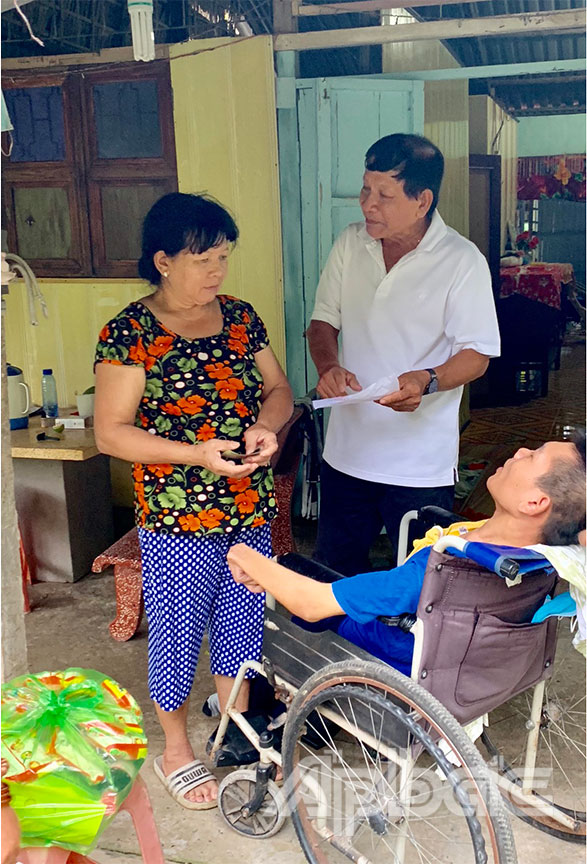 Chủ tịch Hội NNCĐDC xã Lương Hòa Lạc  Kim Hùng thăm hỏi và tặng quà  cho Nguyễn Huỳnh Châu, nạn nhân da cam bệnh nặng, ở ấp Lương Phú C.
