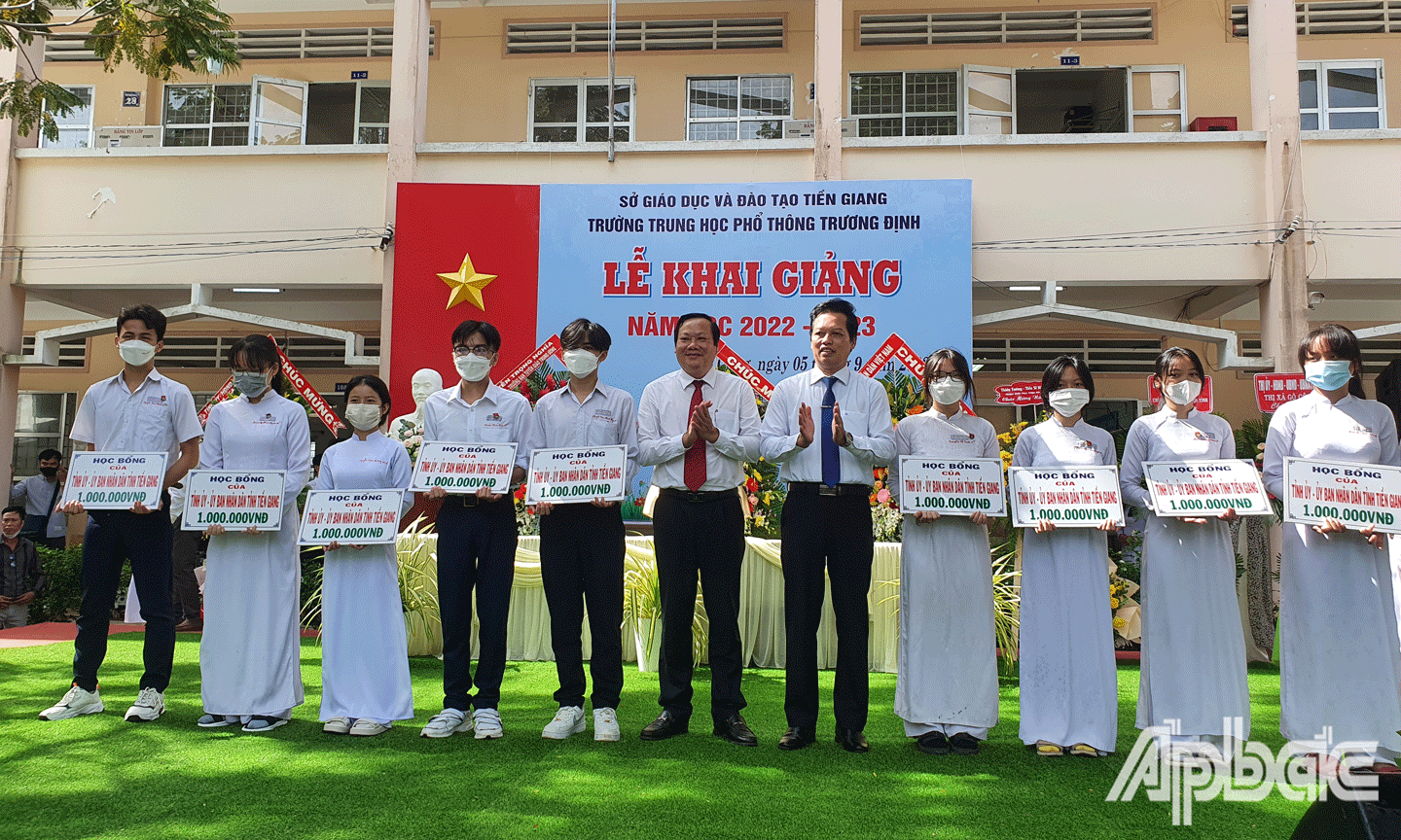 Phó Chủ tịch UBND tỉnh Nguyễn Thành Diệu và Phó Chủ tịch HĐND tỉnh Nguyễn Hữu Lợi trao học bổng cho học sinh. 