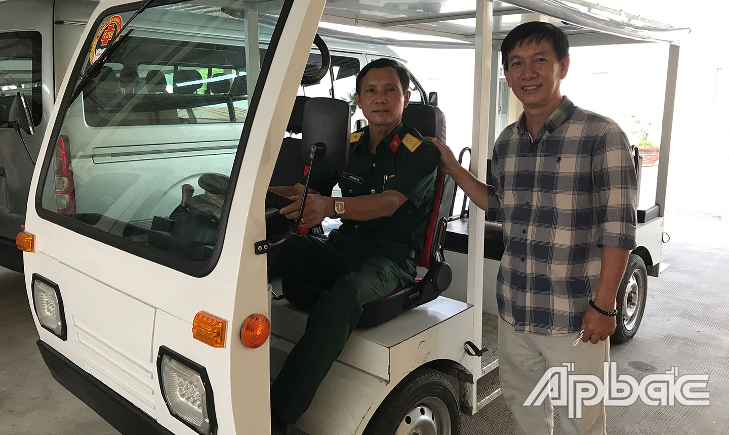 Kỹ sư Nguyễn Thanh Tùng bên cạnh xe điện do anh sáng chế.