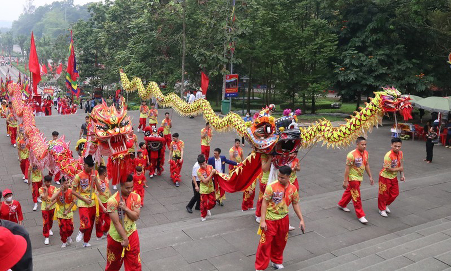 The procession is led by a team of lion and dragon dancers.