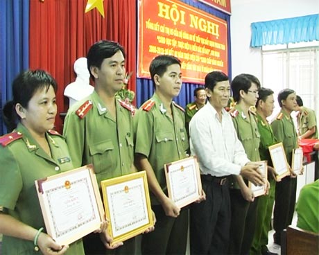 Ông Nguyễn Văn Nhỏ, Trưởng công an huyện khen thưởng các cá nhân  và tập thể xuất sắc. 