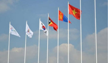 Vietnam’s flag (third pole from right) flies in the sky of the Asian Para Games athletes’ village.