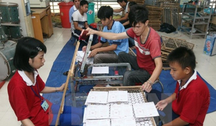 A class at a vocational training centre for people with disabilities in Binh Duong province (Credit: VNA)