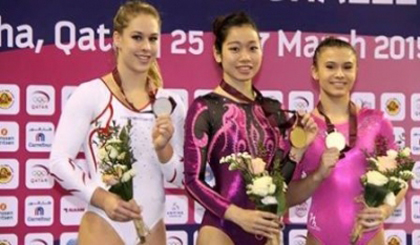 Phan Thi Ha Thanh (C) claims the balance beam gold medal in Doha, Qatar.