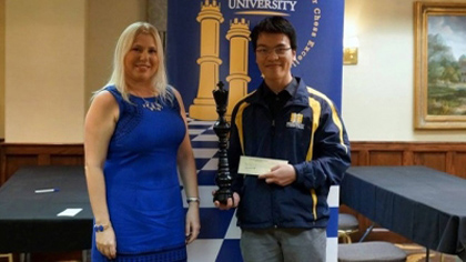 2015 SPICE Cup champion, Le Quang Liem (right) receives the trophy and prize money from Susan Polgar, a well-known Hungarian-born American chess Grandmaster.