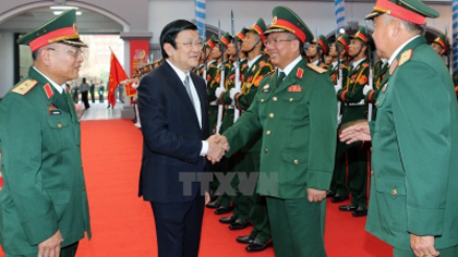 President Truong Tan Sang shakes hands with officials of the General Department of Defence Intelligence at the event. (Image credit: VNA)