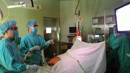 Dr Pham Nhu Hiep and colleagues wear 3D glasses to conduct the surgery.