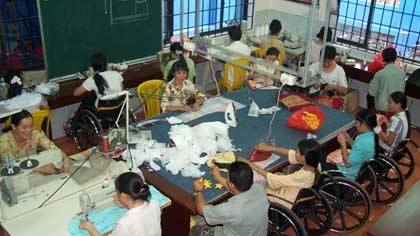 Disabled workers work at a factory. They need more support to get access to education, healthcare and other services. (Source: VNA)