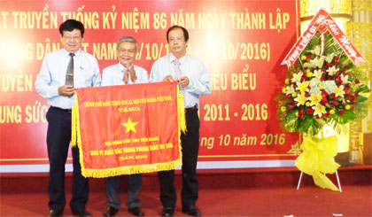 Ông Trần Long Thôn, Ủy viên Ban Thường vụ, Trưởng Ban Dân vận Tỉnh ủy trao Cờ thi đua của Thủ tướng Chính phủ cho HND tỉnh.