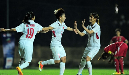 Vietnamese players celebrate Tuyet Dung's opener in their last 2018 Asian Cup qualifying match against Myanmar.