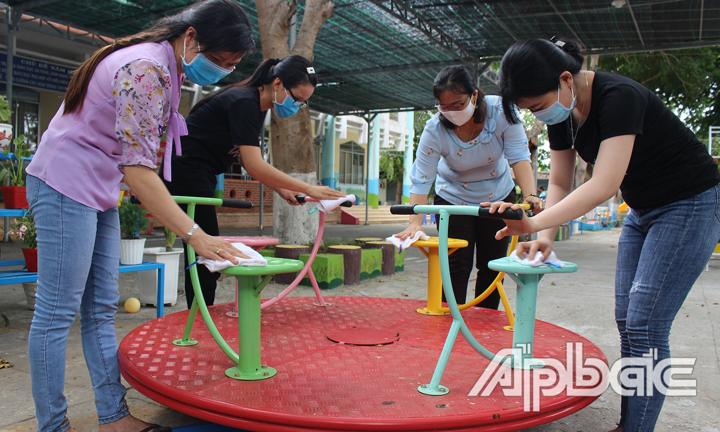 Giáo viên Trường Mầm non thị trấn Mỹ Phước (huyện Tân Phước) tiến hành vệ sinh trường lớp chuẩn bị đón học sinh trở lại trường.                                                                                                         Ảnh: PHI CÔNG