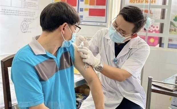 A man gets COVID-19 vaccination (Photo: VNA).