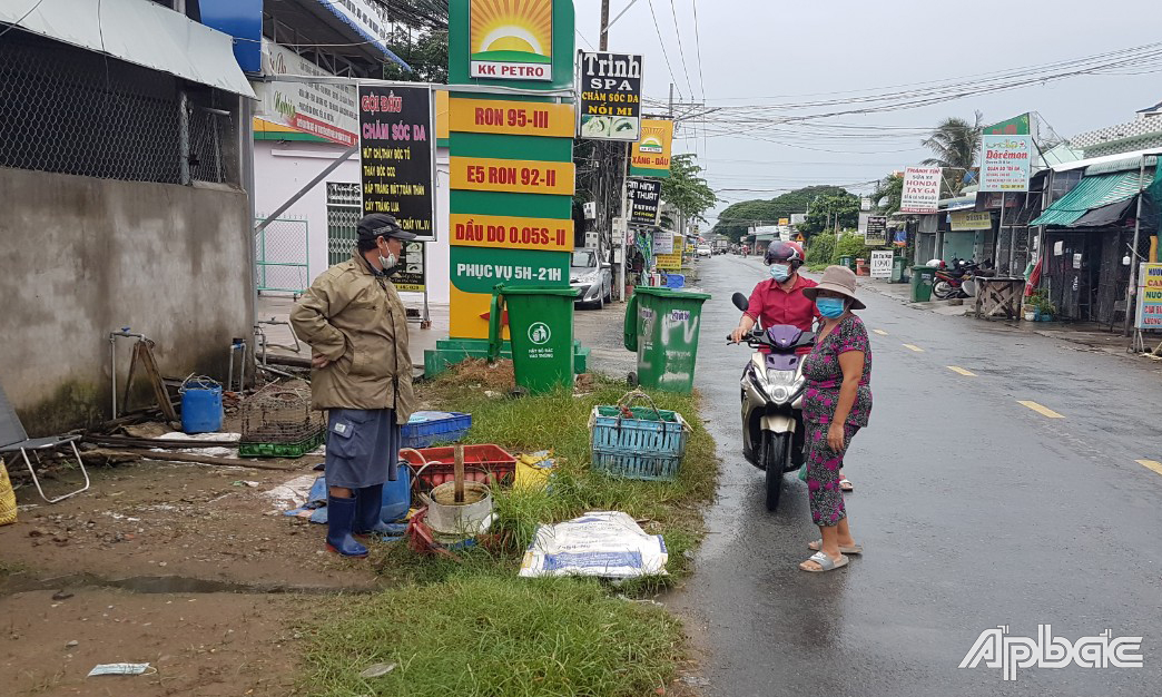 Cán bộ xã Tân Hương vận động người dân bán tự phát ven đường dừng hoạt động.