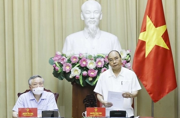  President Nguyen Xuan Phuc speaking at the working session. (Photo: VNA).