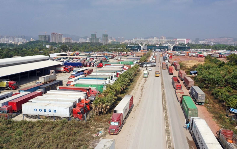 Container trucks wait in long queues for customs clearance at the border gate.