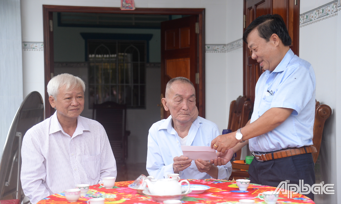 Đồng chí Nguyễn Ngọc Trầm thăm và tặng quà gia đình ông Nguyễn Tấn Đực, tù đày, thương binh, ấp Hòa, xã Dưỡng Điểm.